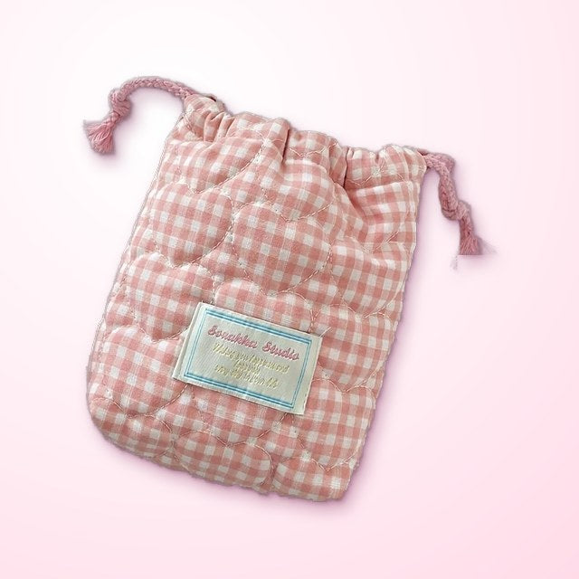 a pink gingham drawstring carry bag