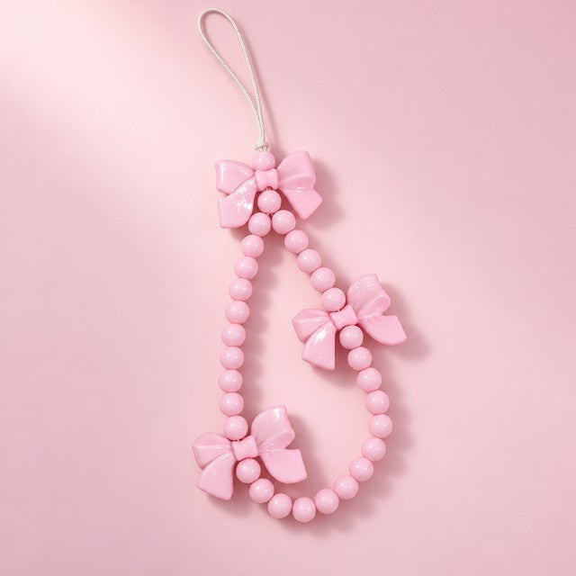 a pink bow beaded charm strap