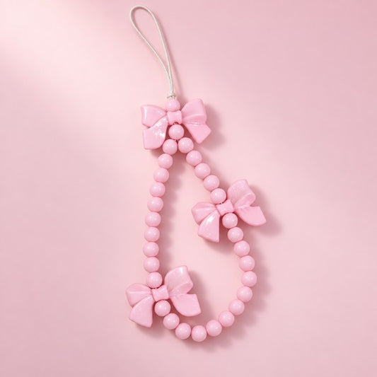 a pink bow beaded charm strap