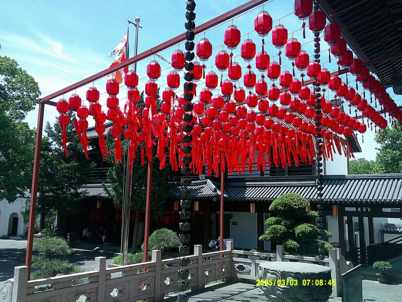 red paper lanterns hanging over a courtyard