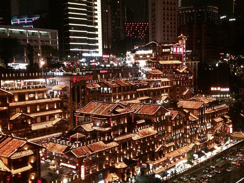 a lit-up hillside town at night