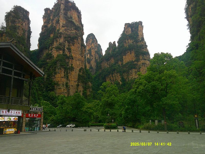 rocky green peaks behind a plaza