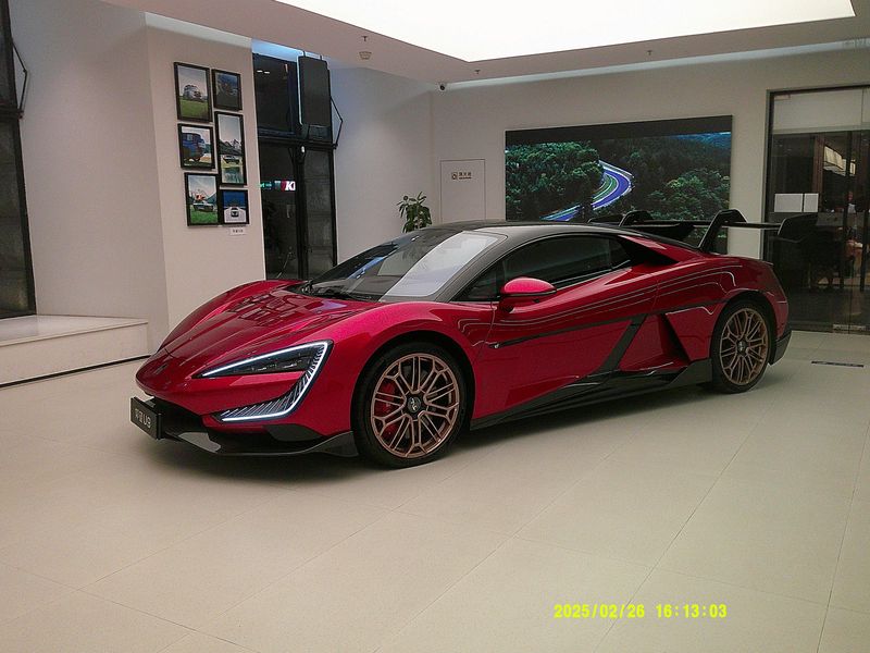 a red sports car in a white showroom