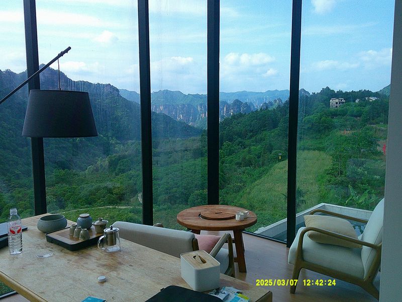 a tea table by a window with mountain views